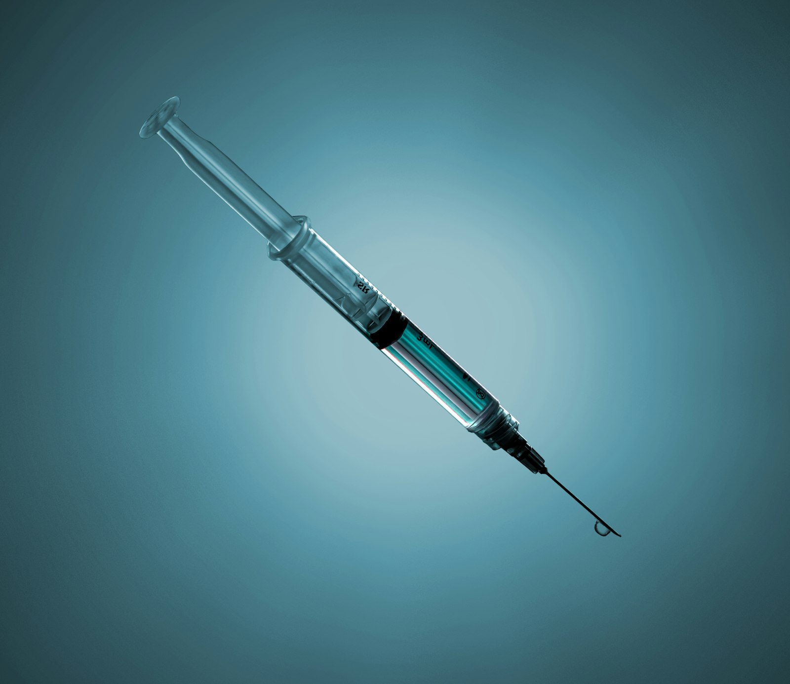 Close-up of a medical syringe against a teal background