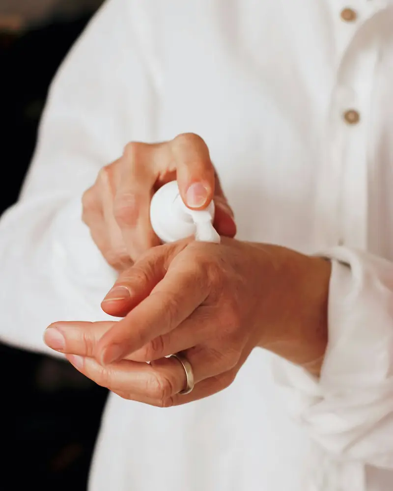 Moisturiser being applied to dry hands