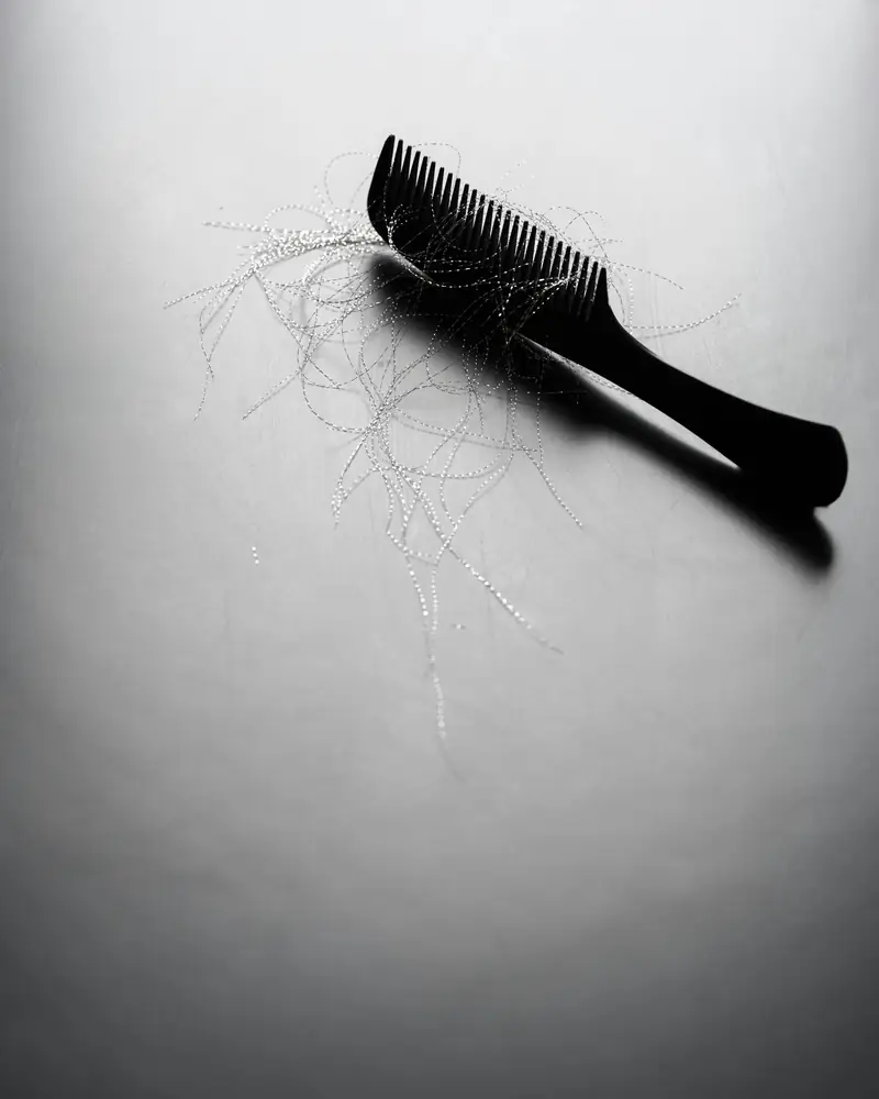 Comb with loose strands of hair
