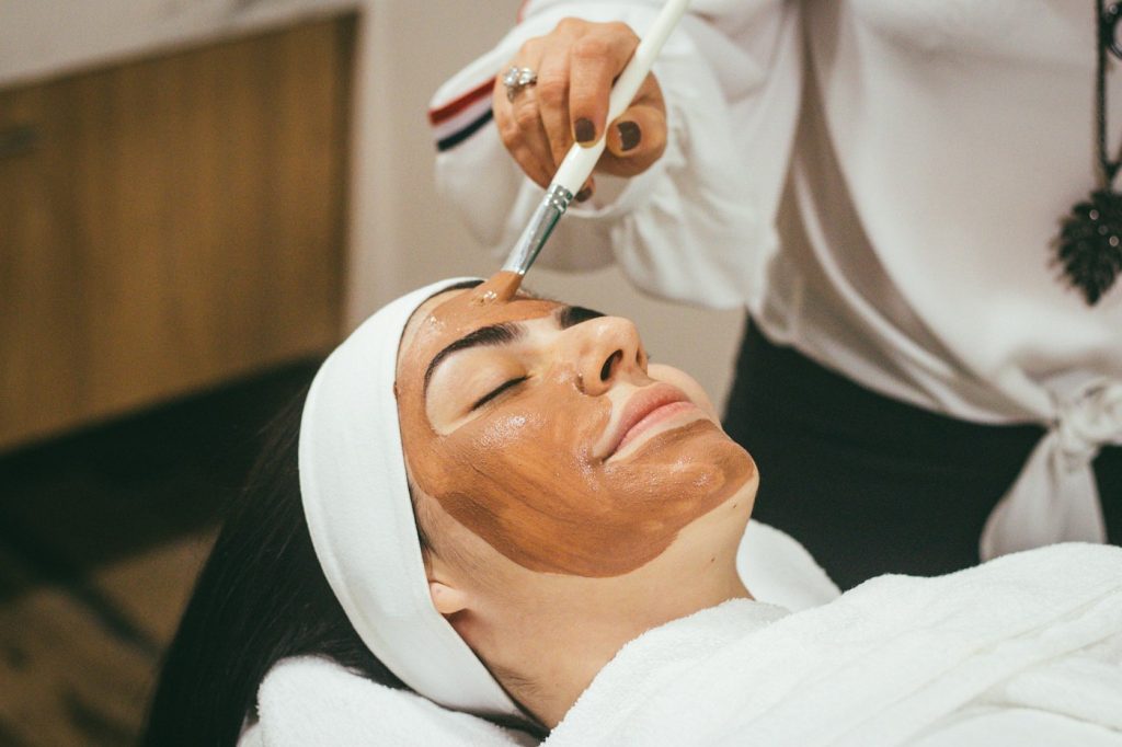 Woman receiving a professional facial mask